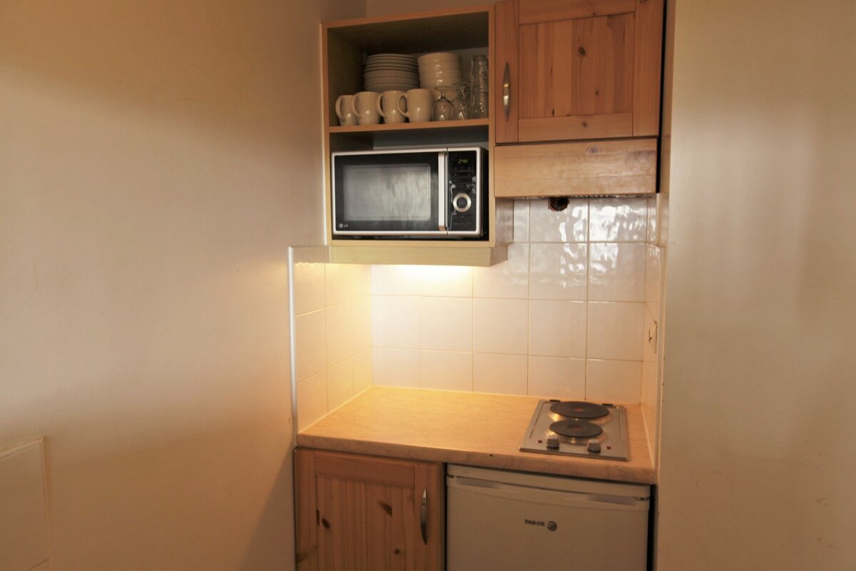 A small kitchen with a lg microwave and a frigidaire