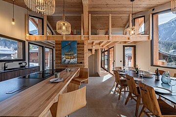 A kitchen and dining area with a table and chairs