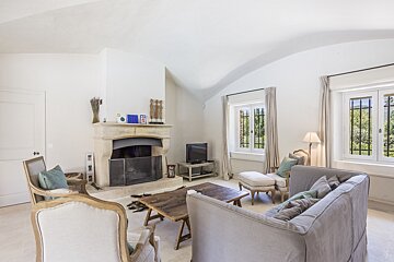 A living room with a fireplace and a television