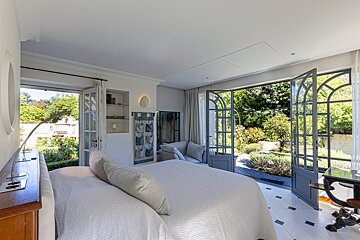 A bedroom with a large bed and a large window