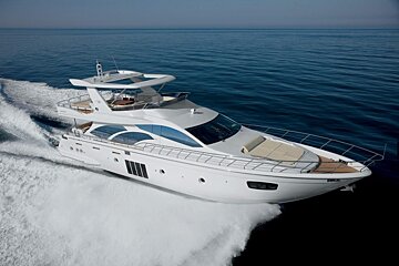 A white yacht is floating on top of a body of water