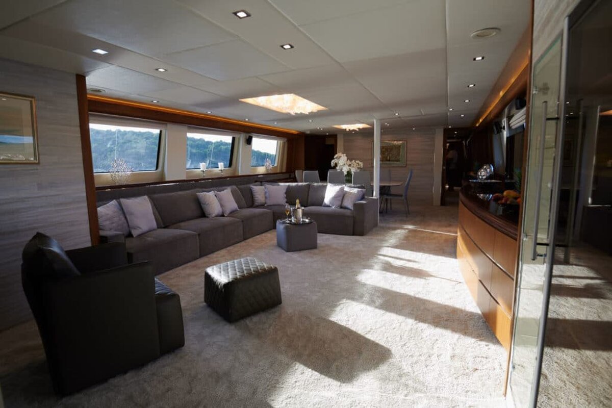 A living room filled with furniture and a table with a bottle of champagne on it