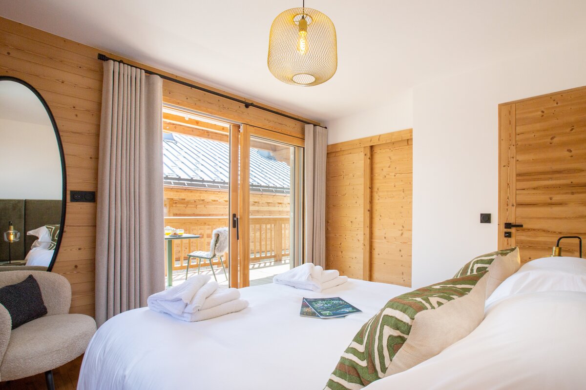 A bedroom with a large bed and a book on the bed