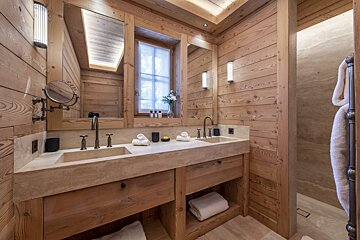 A bathroom with two sinks and a mirror
