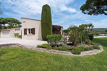 A white house with a few trees in front of it