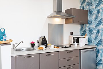 A kitchen with a bottle of aquafina on the counter