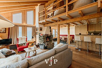 A living room with a fireplace and a vjp logo