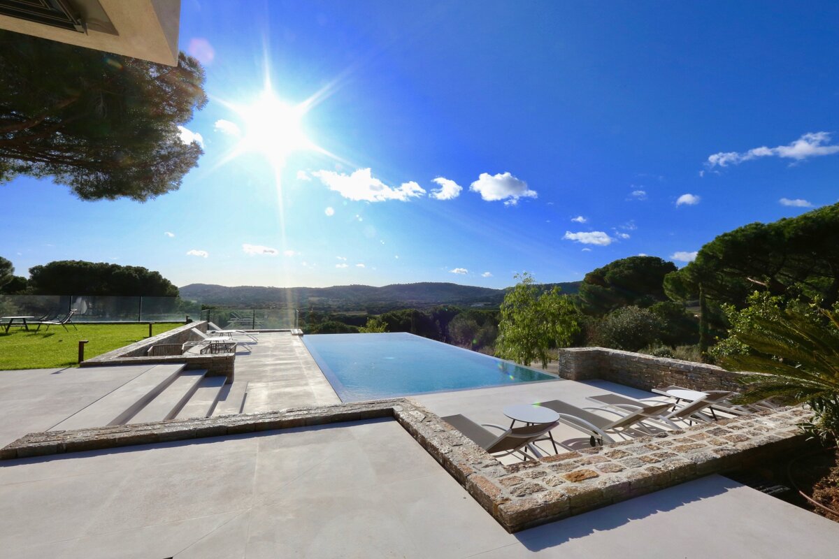 A swimming pool with a view of the mountains in the background