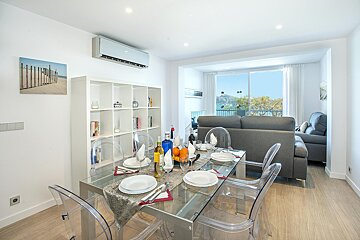 A dining room with a glass table and clear chairs