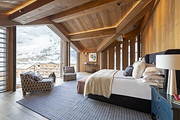A bedroom with a large bed and a large window