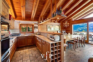 A kitchen with a toaster and a wine rack with the letter v on it