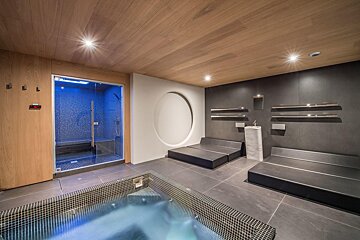 A room with a bathtub and a shower with a circle in the middle