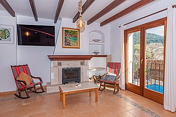 A living room with a fireplace and a flat screen tv