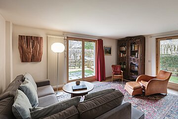 A living room with a couch a chair and a bookshelf