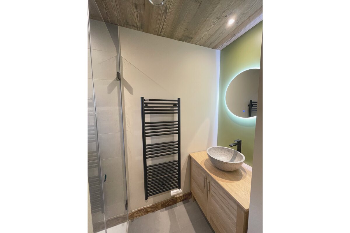 A bathroom with a sink and a towel rack