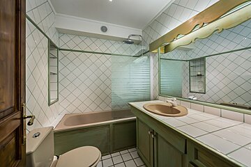 A bathroom with a toilet a sink and a bathtub