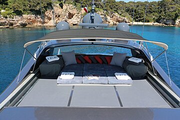 The front of a boat with a few towels on it that say t.p.i