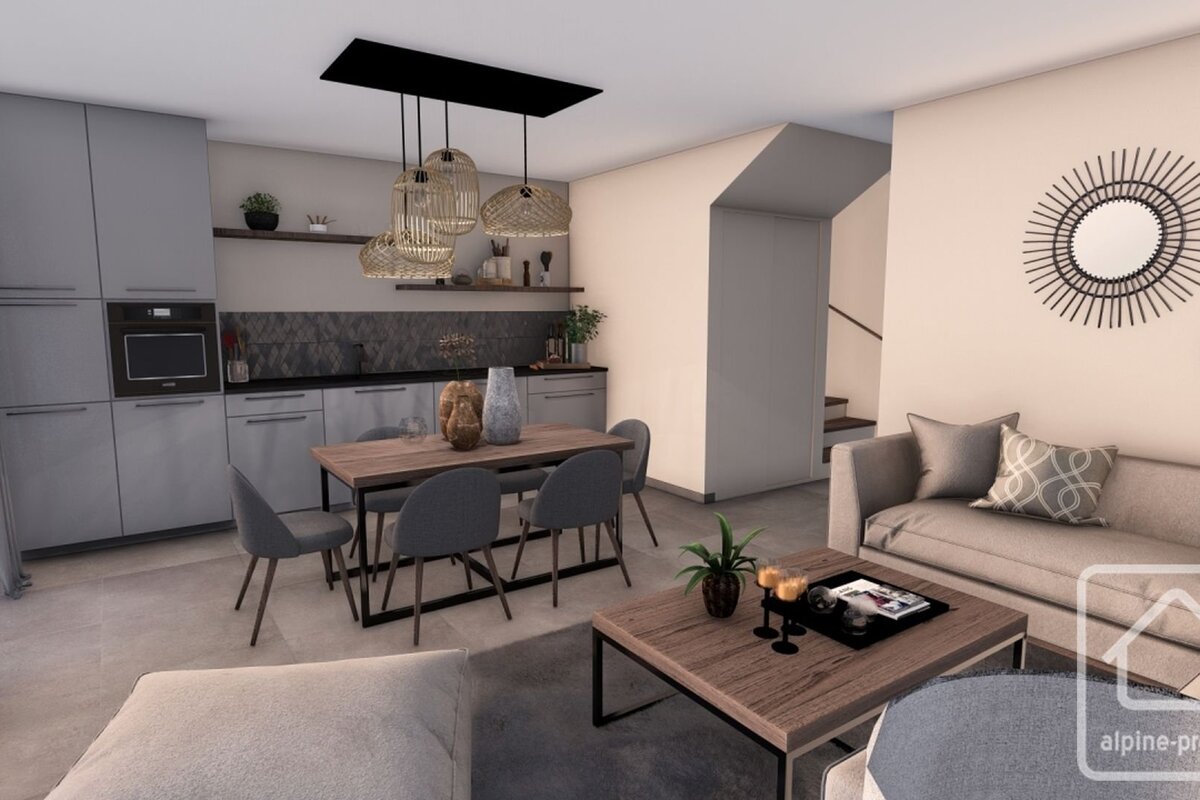 Modern open-plan kitchen, dining, and living area in neutral tones. Features sleek grey cabinets, a wooden dining table, and a comfy sofa.