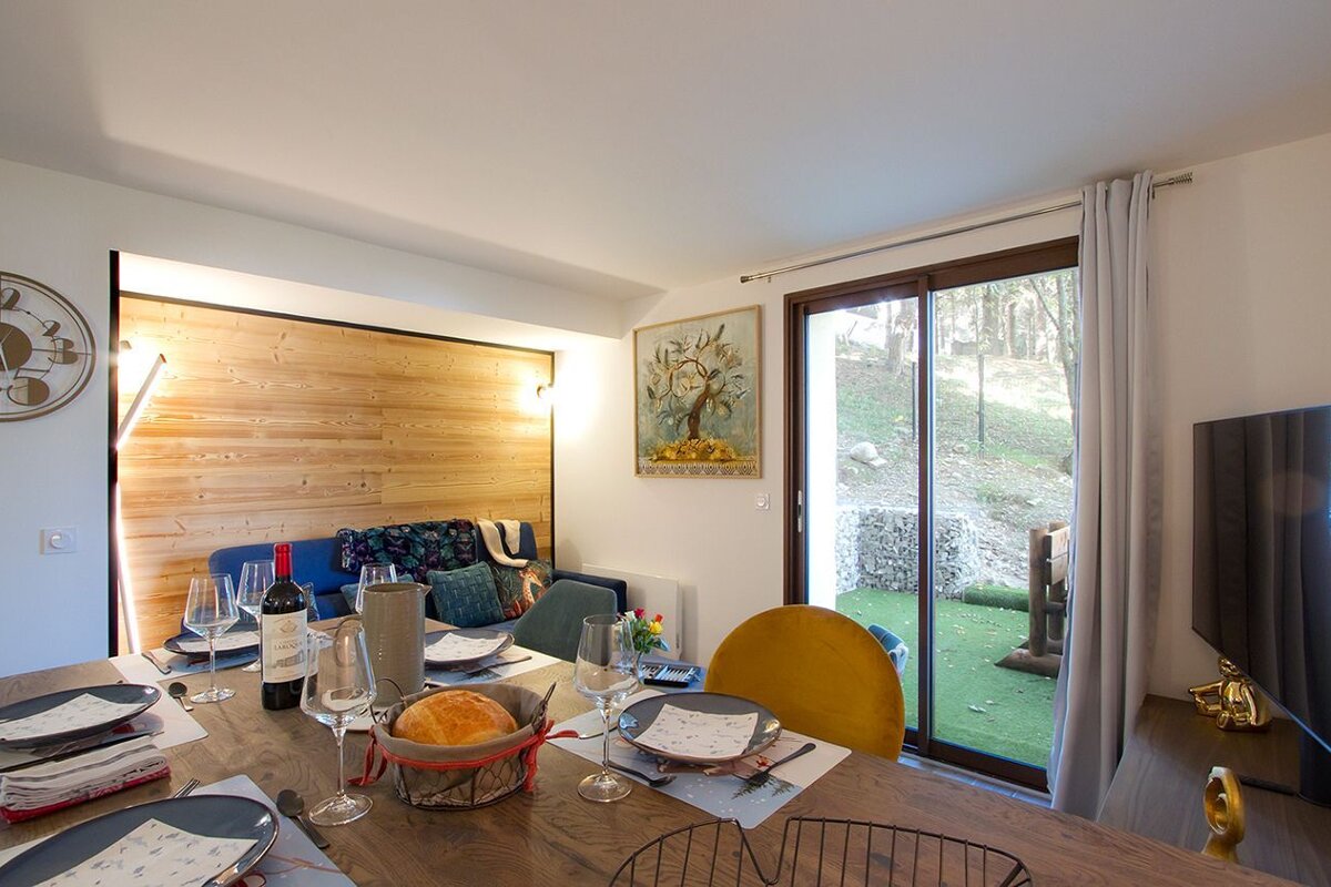 A bottle of red wine sits on a dining table