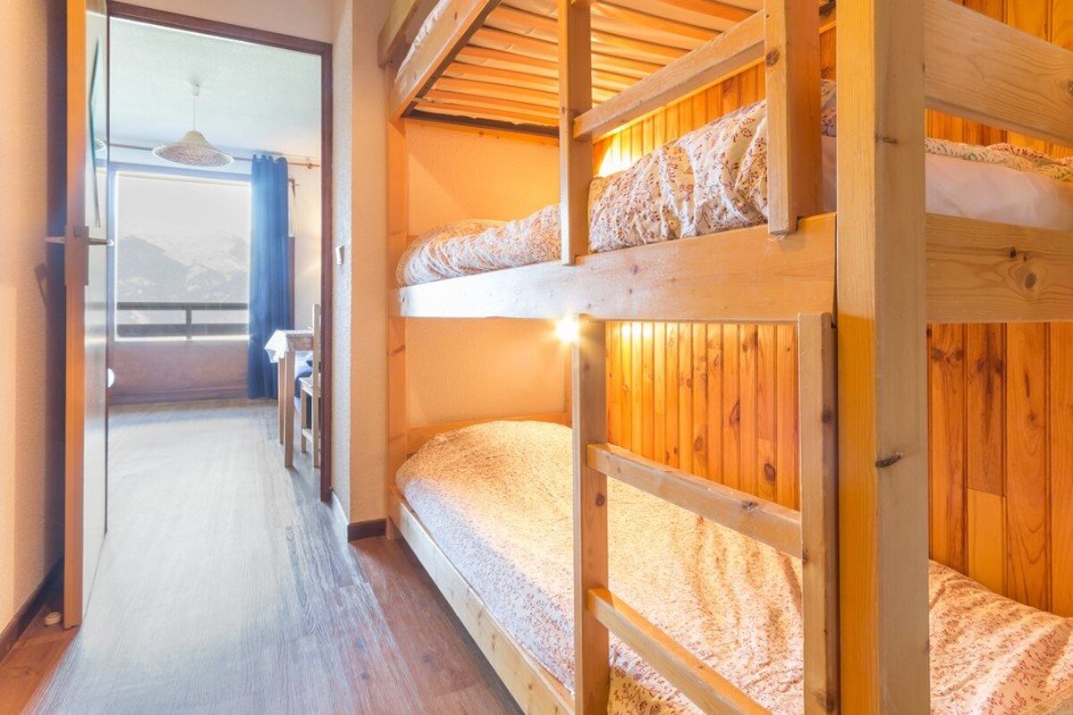 A bunk bed in a room with a view of the mountains
