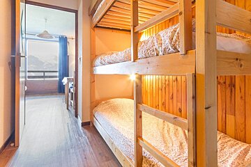 A bunk bed in a room with a view of the mountains