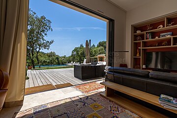 A living room with a sliding glass door leading to a deck