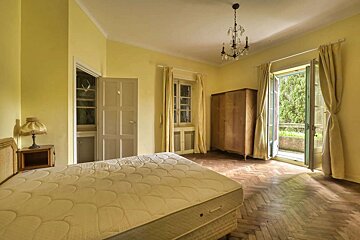 An empty bedroom with a mattress and a lamp