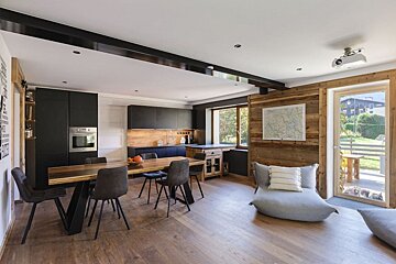 A living room with a table and chairs and a map on the wall