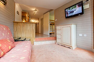 A living room with a couch and a flat screen tv