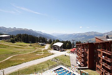 An aerial view of a ski resort with mountains in the background