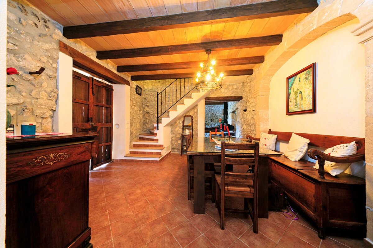 A dining room with a table and chairs and stairs