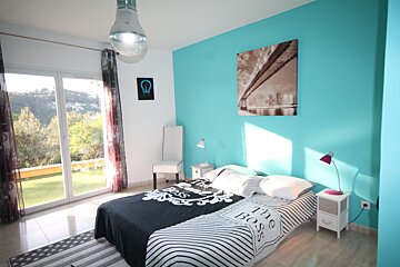 A bedroom with blue walls and a bed that says the boss