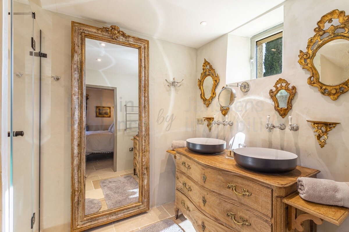 A bathroom with a large mirror and two sinks