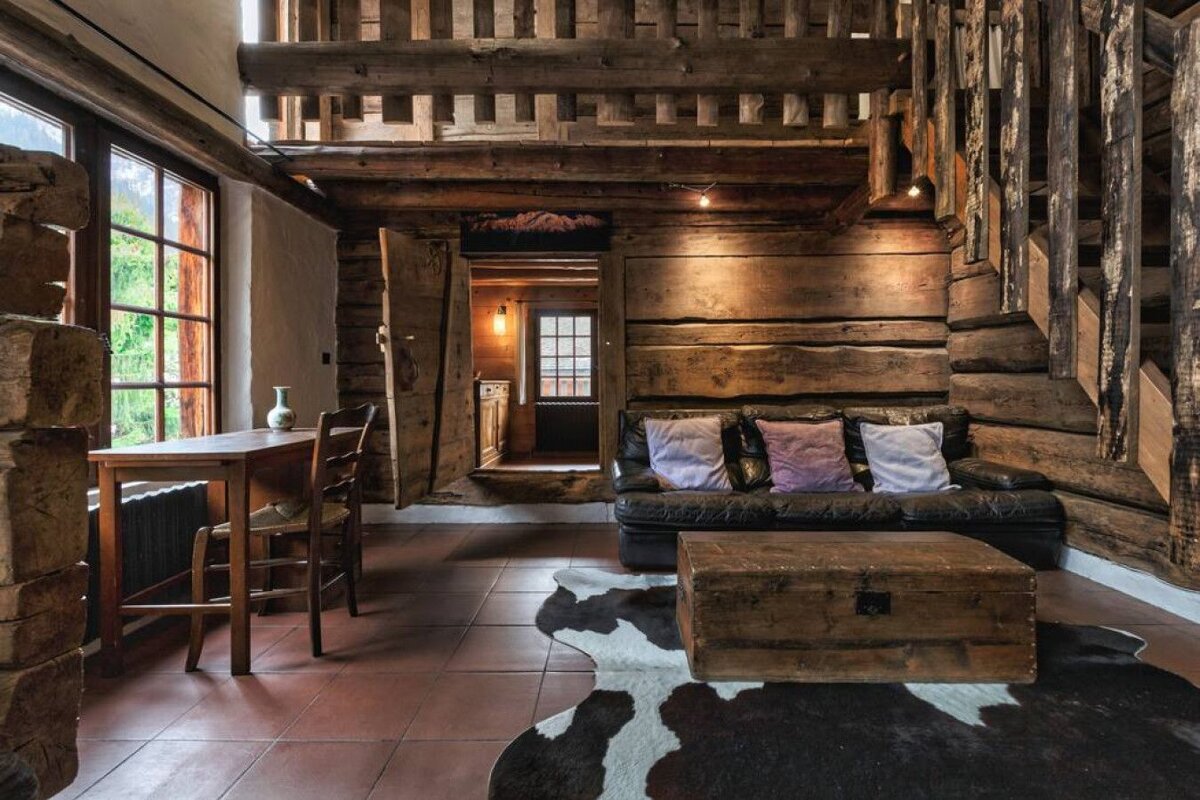 A living room with a couch a table and chairs