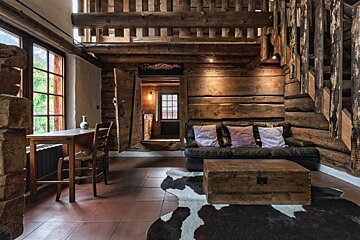 A living room with a couch a table and chairs