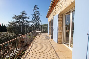 A balcony with blue shutters and the word home on it