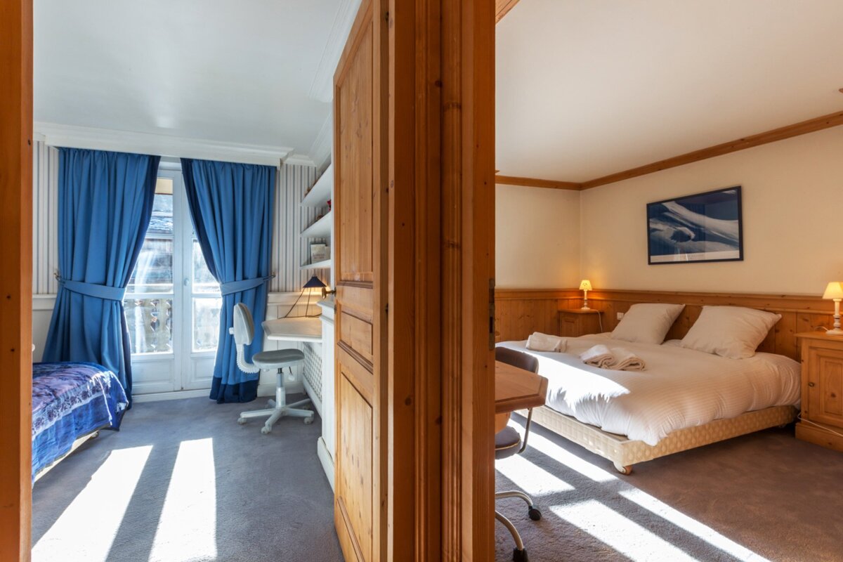 A snowy roof of a house with the sun shining through it