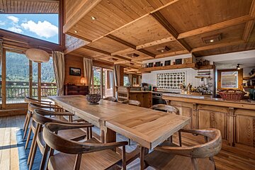 A wooden table and chairs in a kitchen