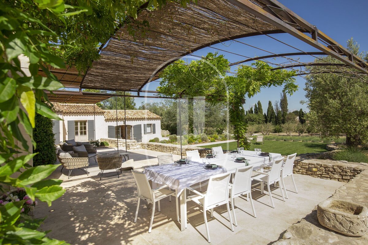 A patio with a table and chairs under a canopy