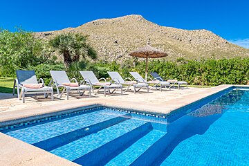 A swimming pool with a mountain in the background