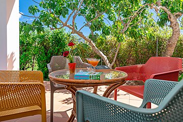 A book on a table with a glass of orange juice