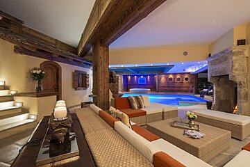 A living room with a fireplace and a swimming pool