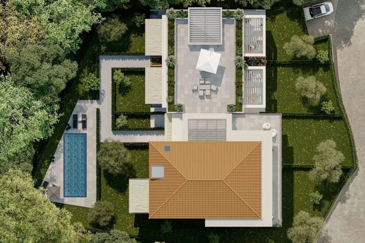 Aerial view of a modern house with a tiled roof, swimming pool, extensive patios with pergolas, lush green gardens, and a car.