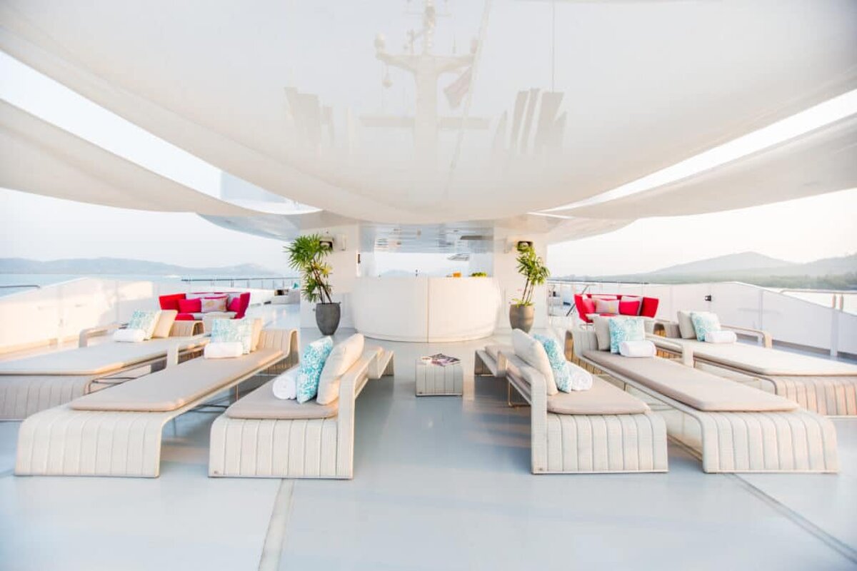 A large white yacht with lots of furniture and a bar