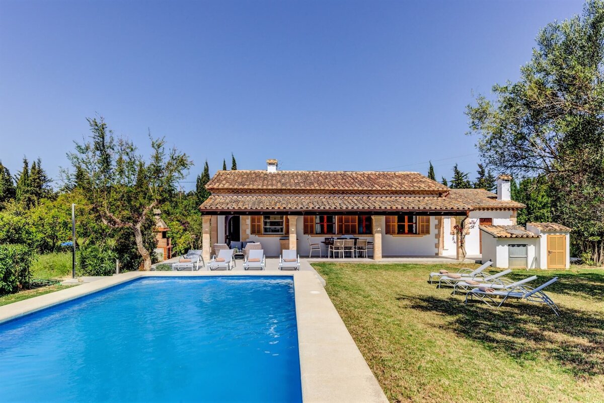 A house with a swimming pool in front of it