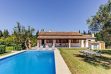 A house with a swimming pool in front of it