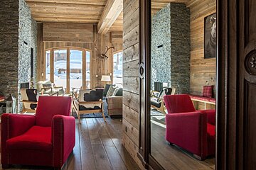 A living room with red chairs and a couch