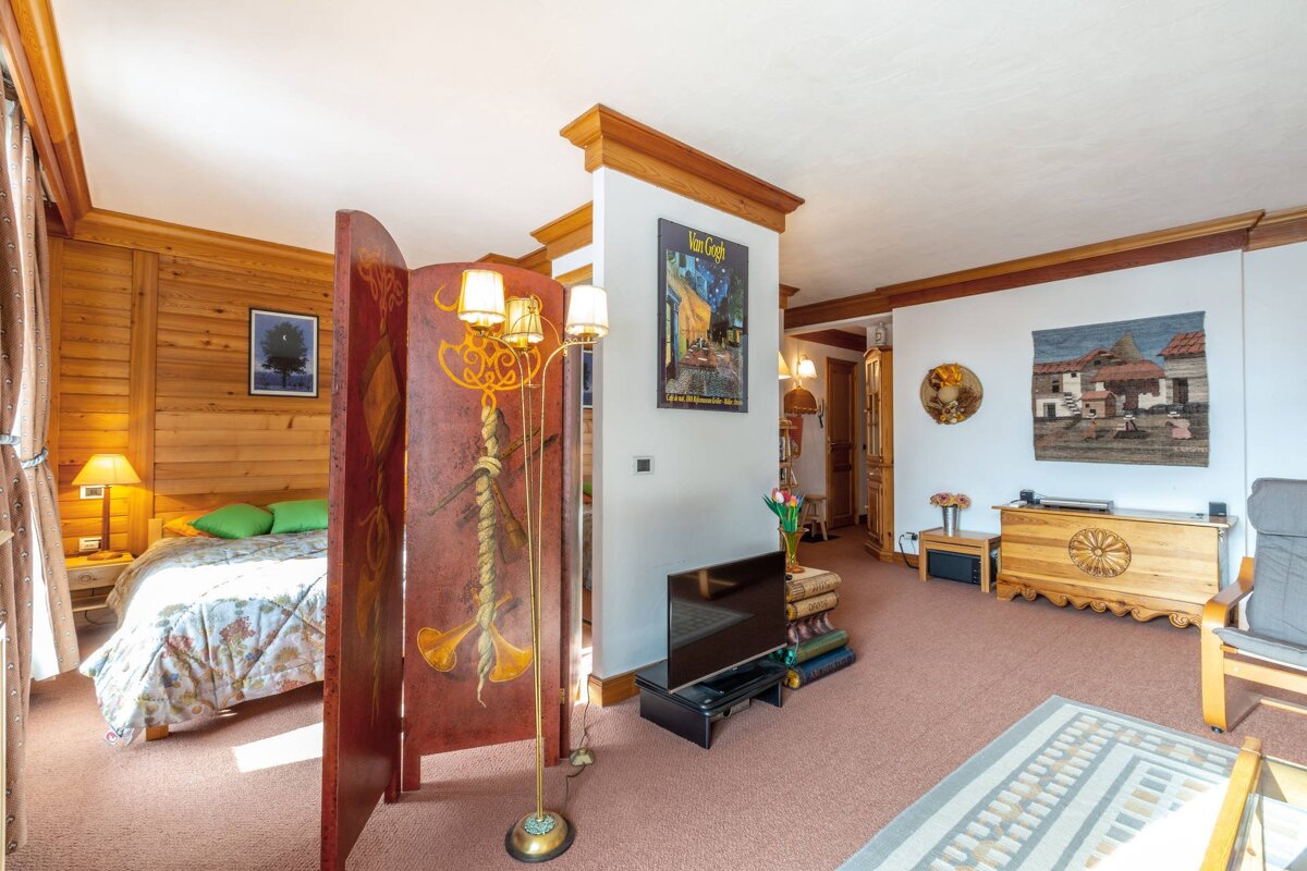 A room with a painting on the wall that says 