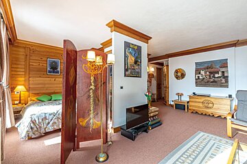 A room with a painting on the wall that says 