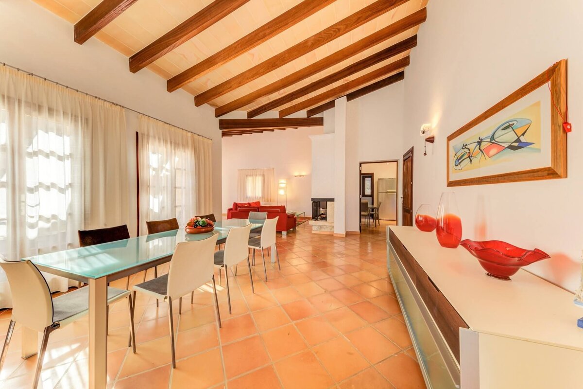 A dining room with a glass table and chairs